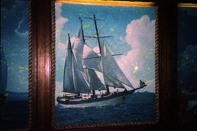 Vintage framed maritime painting of a 19th-century clipper ship under full sail, set against a dramatic twilight sky with sca...