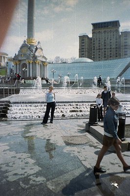 Monumental fountain plaza with tiered water displays & a central obelisk. Architectural style suggests Soviet influence, poss...