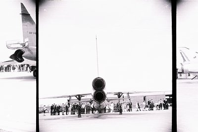 A view of a U.S. Air Force SR-71 Blackbird strategic reconnaissance aircraft on a tarmac. A crowd of people in civilian and m...