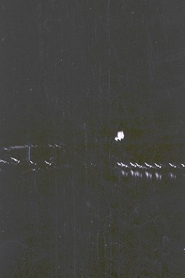 Abstract, monochromatic image showcasing textured surface with scratches and subtle tonal variations. Appears to be a close-u...
