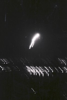 Striking black and white image captures a burst of light and radiating streaks, likely a photographic experiment with motion ...