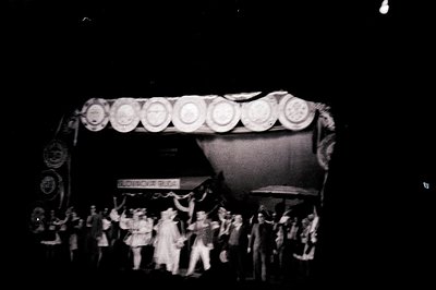 A group portrait, likely a civic or cultural organization, stands before a decorated archway displaying "BOROVA BALDA." The a...