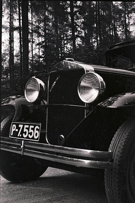 Detailed view of a vintage automobile, likely a 1930s model, displaying its distinctive front grille and headlights. A licens...