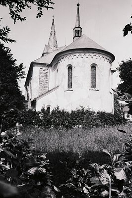 Round church with a steeple; Romanesque design details including arched windows and a decorative cornice. Likely a rural chap...