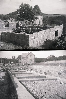 A construction site in progress; stone foundation nearly complete, with a worker visible on the structure. A partially-built ...