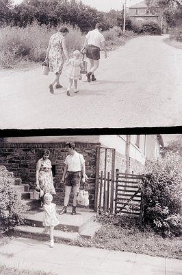 A family – mother, father, and young daughter – descends stone steps along a narrow, curving lane. The mother carries a baske...