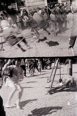 A candid street scene captures movement – a child runs past a set of vintage playground equipment, including a rocking horse ...
