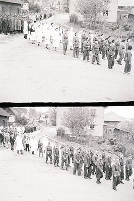 A long procession of medical personnel, primarily women in white uniforms and a contingent of uniformed soldiers, march along...