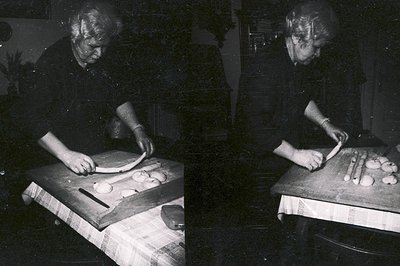 An elderly woman, likely in a home kitchen, kneads dough on a wooden board covered with a checkered cloth. Visible are loaves...