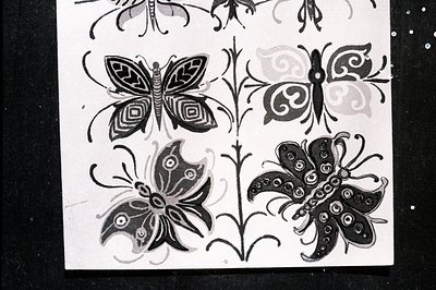Detailed black and white illustration depicting stylized butterflies and floral motifs. The design uses concentric circles an...