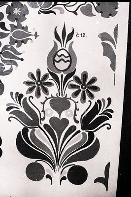 Detailed floral motif in stark black and white. Features stylized tulip, leaves, and blossoms, characteristic of Balkan folk ...