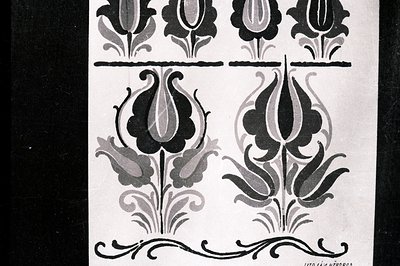 Detailed black-and-white botanical illustration, showcasing stylized tulip motifs with curvilinear foliage and a decorative h...