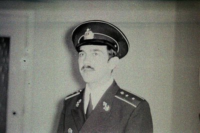 Military officer portrait, likely from the 1960s or 1970s. He wears a peaked cap with insignia, a double-breasted uniform wit...