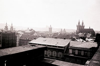 Panoramic view of Prague, Czech Republic, showcasing rooftops and historic spires rising above the city. Dominated by church ...