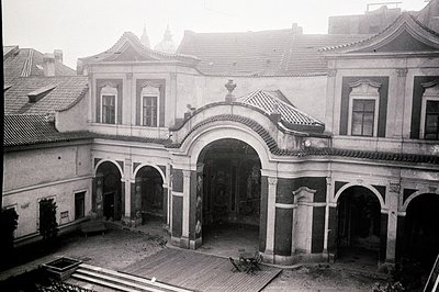 Ornate, two-story villa with arched loggia overlooking a courtyard. The architectural style suggests late 19th/early 20th cen...