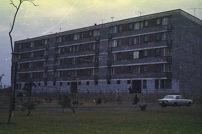 Massive, austere apartment block, likely constructed during the socialist era. Features repetitive balconies & visible antenn...