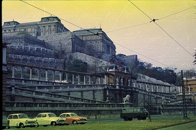 Ornate, tiered terrace and monumental building, likely a palace or villa, rises above a street scene. Classic architecture fe...