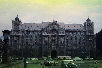 Grand, ornate facade of the Gellért Baths in Budapest, Hungary. A multi-story building features intricate stonework, arched w...