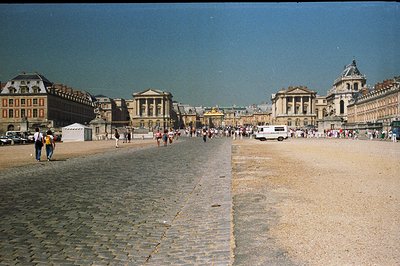 A wide, expansive view of the Place d'Armes in Strasbourg, France. Formal architecture featuring ornate facades, a central fo...