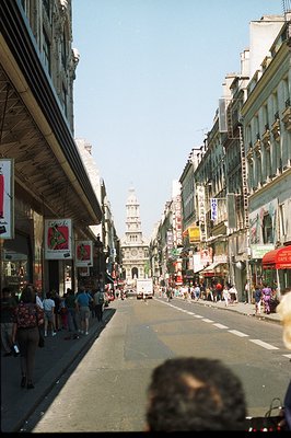 A bustling pedestrian street scene in what appears to be France, likely the 1980s based on fashion and signage. The view exte...