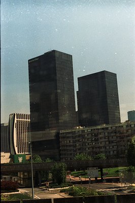 Two imposing, dark glass office towers dominate this view, branded with “Winterthur” signage. Mid-century modern architecture...