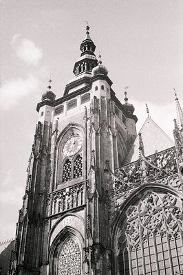 Striking black & white image of Prague’s Old Town Hall tower, showcasing intricate Gothic architecture & a prominent clock fa...