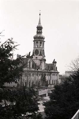 Ornate, multi-tiered building with a prominent central spire and arched loggia. Likely a public building or stately home, pos...