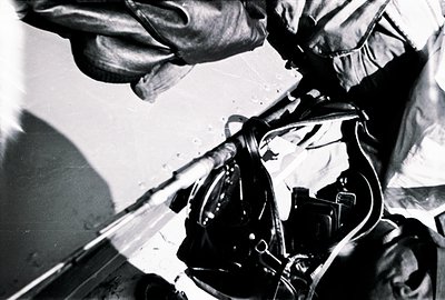 High-angle, monochrome image depicting a climber's gear. Focus on carabiners, ropes, and a harness, suggesting alpine or rock...