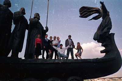Statue group depicting sailors in traditional attire, with modern figures posing atop a ship’s bow. Likely 1970s–1980s Easter...