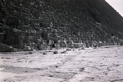 Close-up of ancient limestone blocks arranged in precise horizontal layers, forming part of the Great Pyramid of Giza. The st...