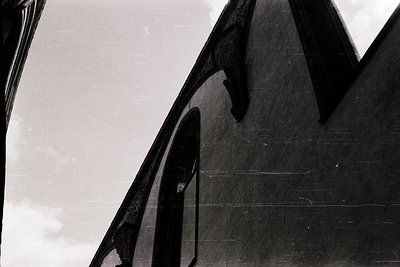 Black-and-white close-up of a **modernist architectural detail**—exaggerated, angular concrete forms with sharp, geometric ed...