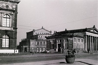Neoclassical stone building with Corinthian columns and arched windows, likely a public institution from the early 20th centu...