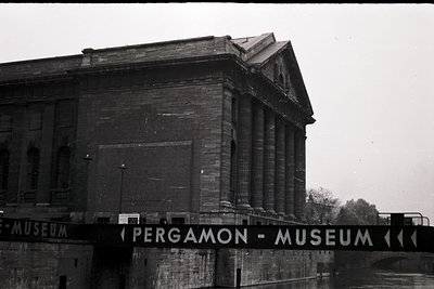 Neoclassical Pergamon Museum façade in Berlin, Germany, featuring grand columns and a pediment. Black-and-white photo capture...