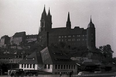 Historic Gothic cathedral with twin spires and fortified monastery complex perched on a hillside, likely ßen (, ). Mid-20th c...