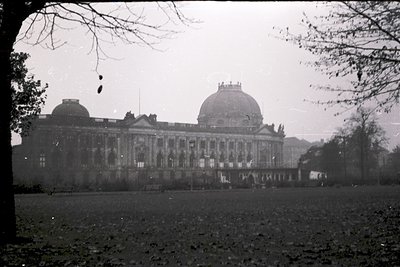 Neoclassical building with domed roof and symmetrical facade, likely a historic institution. Ornate columns and arched window...