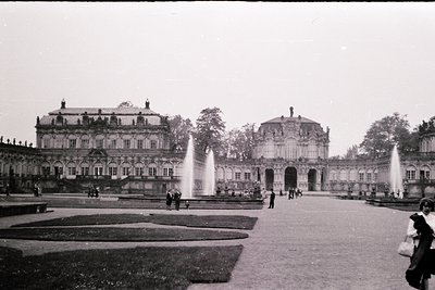 Baroque-style palace courtyard with symmetrical fountain designs, grand arches, and classical columns. Likely **Zwinger Palac...