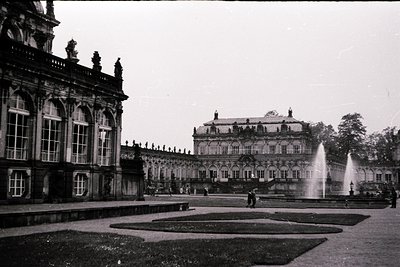 Baroque palace courtyard with classical columns, arched windows, and symmetrical fountain design. Likely **Cecilienhof Palace...