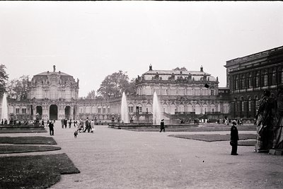 Neoclassical palace courtyard with grand fountains, symmetrical architecture, and ornate columns. Mid-20th century (likely 19...