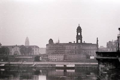 Historic waterfront view of a grand, multi-towered building with Gothic Revival architecture, likely a palace or government c...