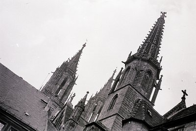 Gothic-style twin spires with intricate stone detailing, likely part of a cathedral or church. The architecture features poin...