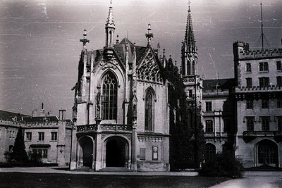 Gothic Revival-style church facade with pointed arches, intricate tracery, and twin spires. Symmetrical design features a cen...