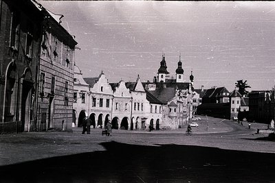 Vintage black-and-white street scene featuring **historic European architecture**—notable for stepped gable roofs and arched ...