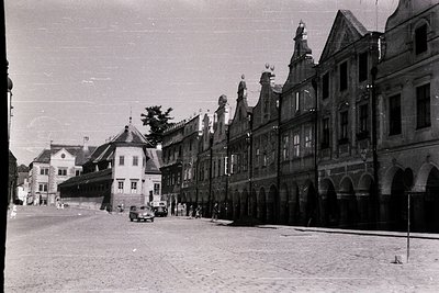 Historic European street scene featuring timber-framed buildings with stepped gables, likely . Cobblestone pavement and vinta...