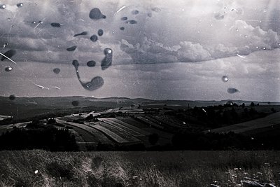 Vintage black-and-white aerial view of agricultural fields with geometric crop patterns, likely wheat or barley. Distinctive ...