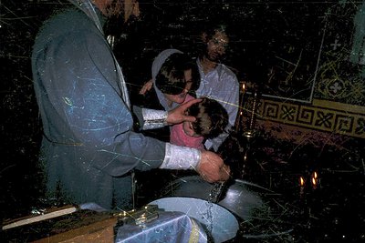 Orthodox baptism ritual with priest anointing infant’s forehead in holy oil (). Icon of Christ Pantocrator and Greek Orthodox...