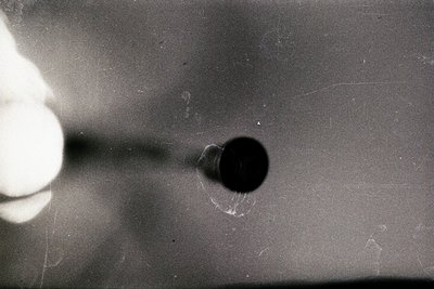Close-up of a vintage camera lens with a visible aperture ring set to f/2.9. The metallic barrel shows minor scratches and we...