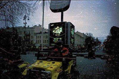 Vintage urban street scene featuring a vintage Samsung billboard atop a yellow truck, likely from the **1980s-1990s**. Snow-c...
