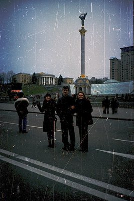Three individuals pose in winter attire near Independence Monument (), Kyiv, Ukraine. Soviet-era architecture and Soviet-era ...