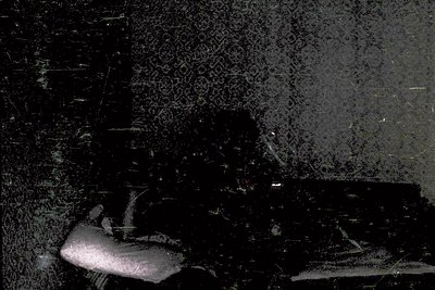 Vintage black-and-white photo of a **fisherman’s net** spread over a **textured, weathered surface** (likely concrete or ston...