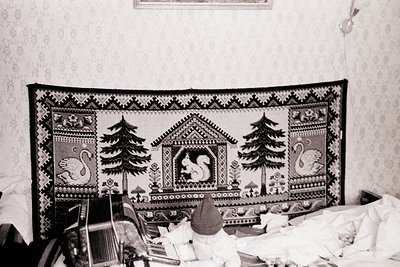 Vintage embroidered textile featuring symmetrical forest motifs: two pine trees flanking a central squirrel perched on a deco...